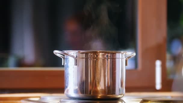Pan on the hob. Steam coming - On the background of the window - Footage, Video