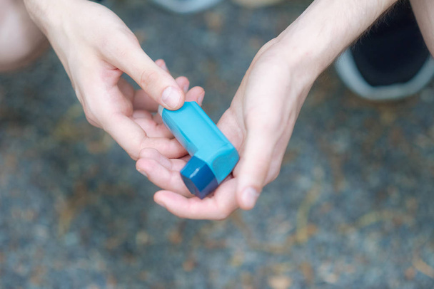 Astma medecine inhalaattori pitää kaksi kättä miehen
 - Valokuva, kuva
