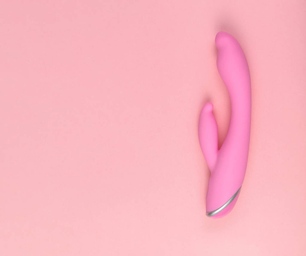 Beautiful evenly lit pink dildo on a glamorous background with copy space. - Foto, immagini