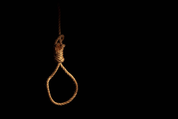 Loop of braided rope on a gloomy dark background, failure or suicide concept - Fotoğraf, Görsel