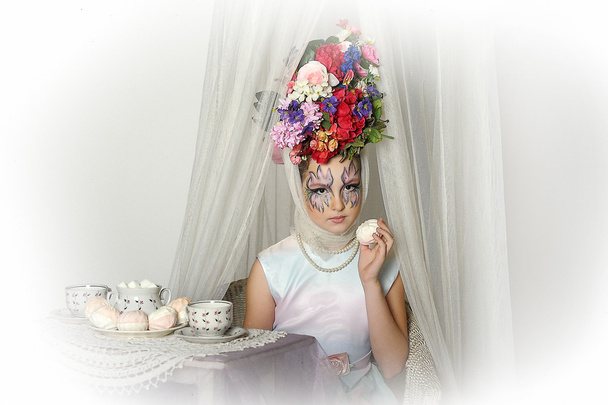 Girl with flowers on her head during a tea party - Foto, Imagem