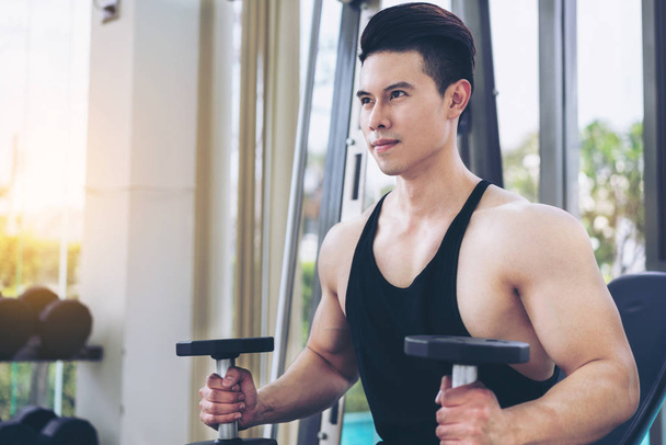 Muscular man bodybuilder training with dumbbells. - Фото, изображение
