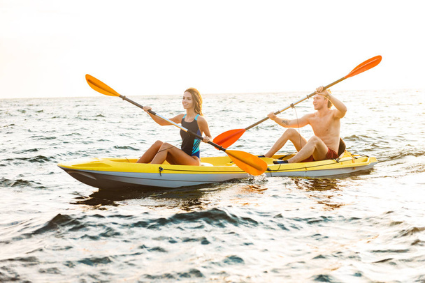 Sporty attractive couple kayaking - Zdjęcie, obraz