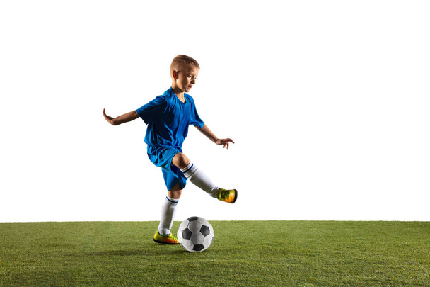 Young boy as a soccer or football player on white studio background - Фото, изображение