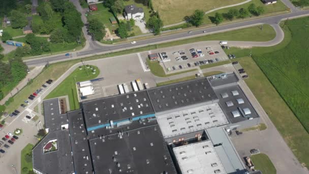 Aerial view of the logistics warehouse with trucks waiting for loading - Footage, Video