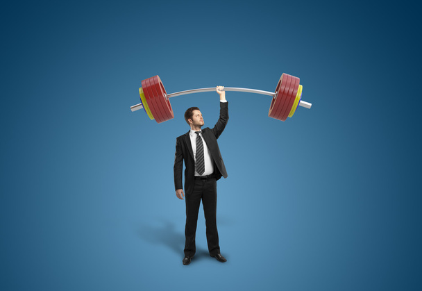 businessman holding barbell - Photo, Image