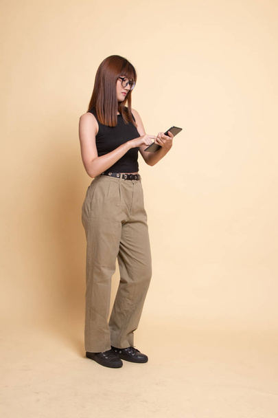 Full body of young Asian woman with a computer tablet. - Fotó, kép