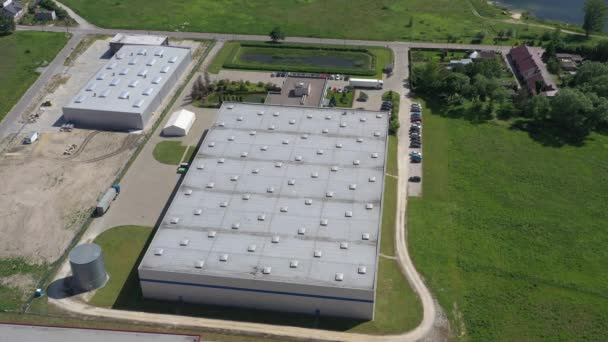 Aerial view of the logistics warehouse with trucks waiting for loading - Footage, Video