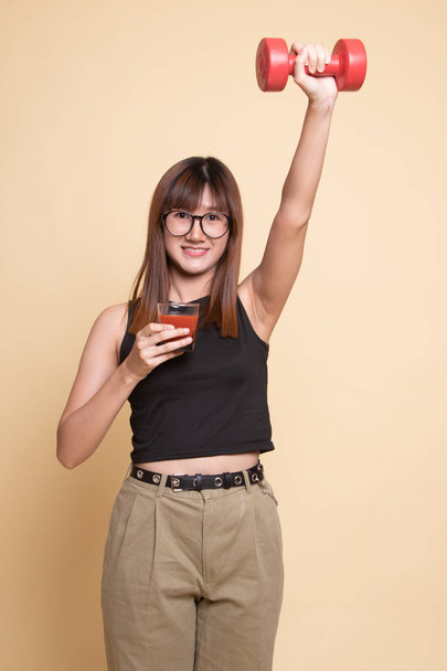Healthy Asian woman with dumbbell and  tomato juice. - Photo, Image