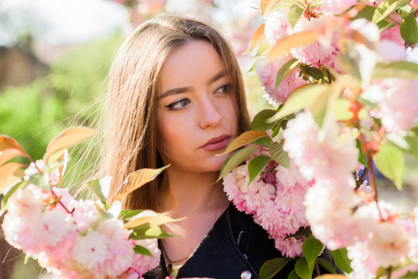 Spring in my head. blossom smell, allergy. girl in cherry flower. Sakura tree blooming. natural summer beauty. skincare and spa. Natural cosmetics for skin. woman in spring flower bloom - Foto, Bild