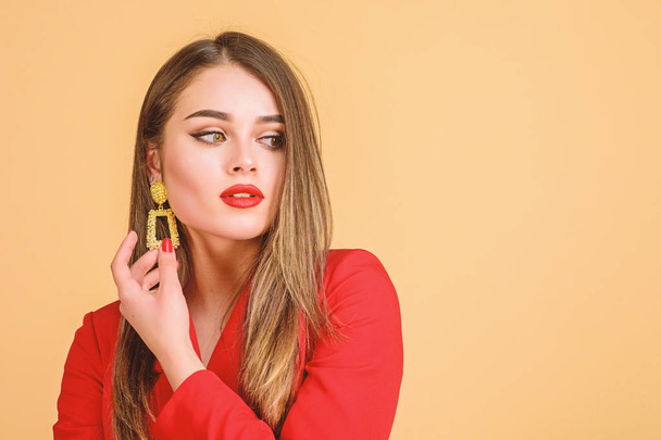 Jewelry shop. Girl model long hair demonstrating golden jewelry earrings. Expensive accessory. Fashionable jewelry. Impeccable makeup and perfect jewelry. Woman wear glamorous earrings. Fashion trend - Photo, Image