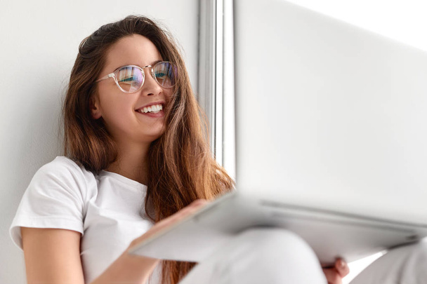 Cheerful young woman making video call on laptop  - Фото, зображення