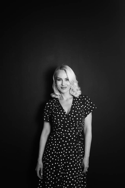 Portrait of a blonde woman in a black dress - Photo, Image
