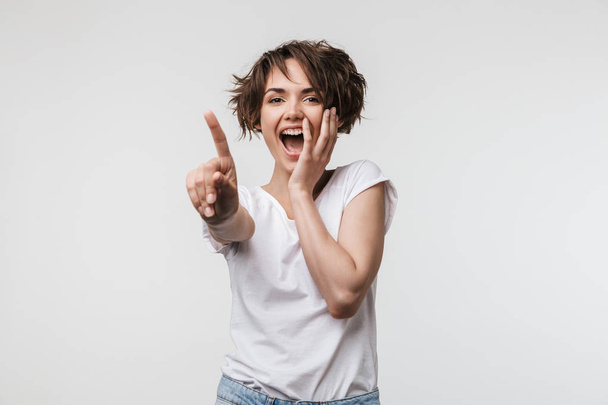 Image of young woman with short hair in basic t-shirt smiling an - Фото, зображення