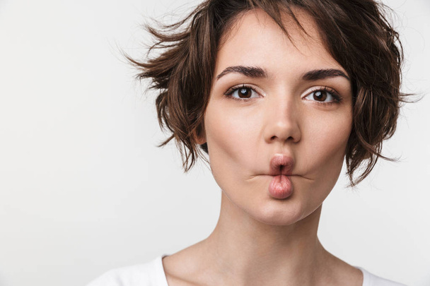 Portrait closeup of funny woman with short brown hair in basic t - 写真・画像