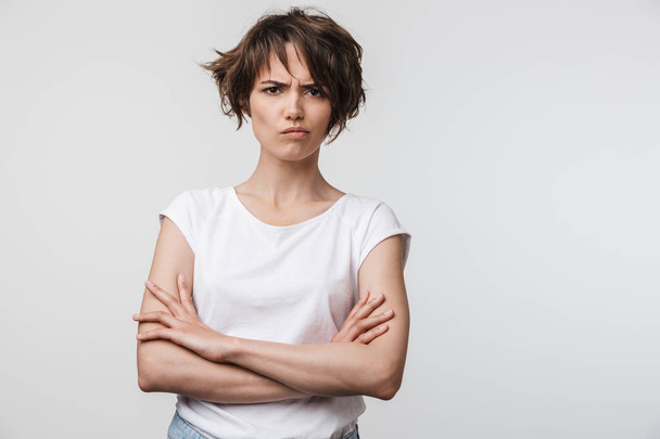 Portrait of irritated woman with short brown hair in basic t-shi - Фото, зображення