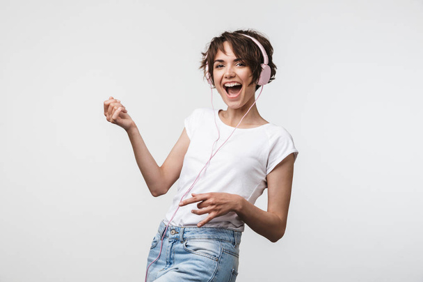 Image of european woman in basic t-shirt playing invisible guita - Foto, immagini