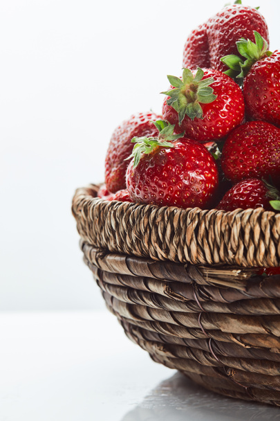 fresh red strawberries in wicker basket on white - Photo, image