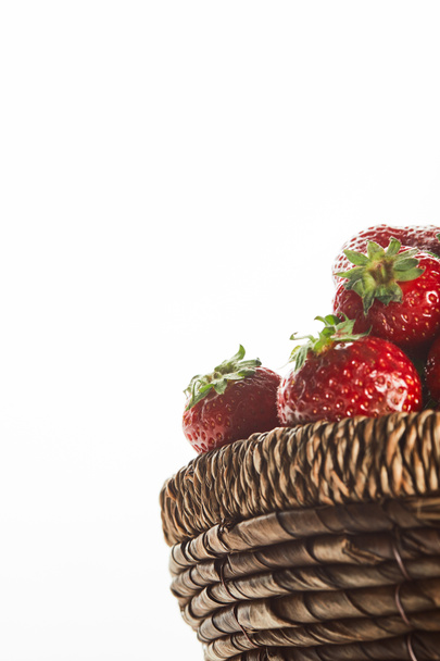 red sweet strawberries in wicker basket isolated on white - Fotoğraf, Görsel