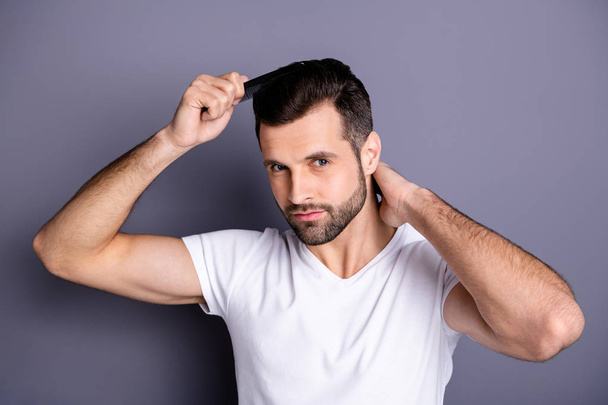 Close up photo amazing he him his macho perfect appearance hands arms plastic hair styling brush take care hairdo after barber shop stylist visit wear casual white t-shirt isolated grey background - Foto, afbeelding
