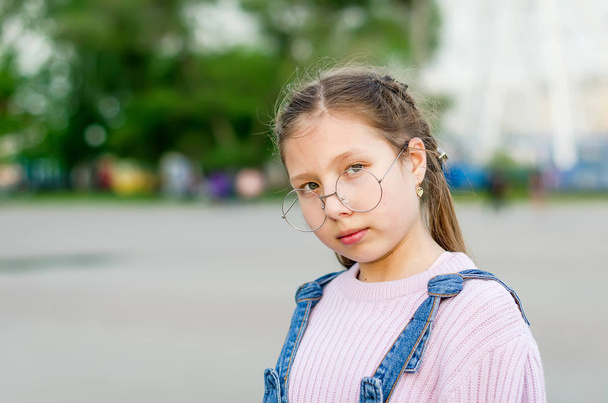 portrait of stylish smiling teen girl with glasses in the street - Photo, image