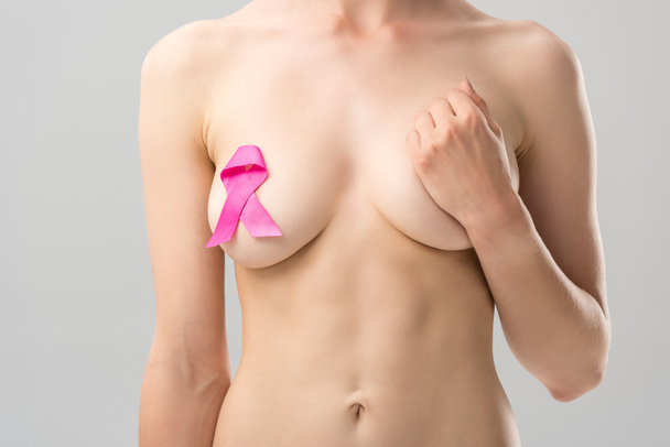 cropped view of naked young woman with pink ribbon isolated on grey - Fotografie, Obrázek