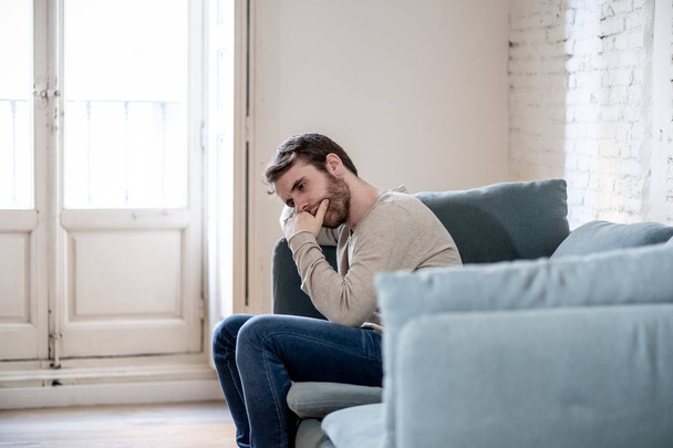 Unhappy depressed caucasian male sitting and lying in living room couch feeling desperate a lonely suffering from depression. In stressed from work, anxiety, heartbroken and men Health care concept. - Foto, Imagen