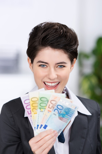 Businesswoman Holding Fan Of Euro Notes - Фото, зображення