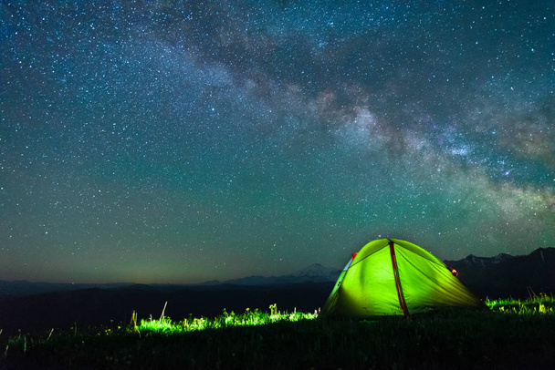 tourist tent of green color against the night sky with the Milky Way - Фото, зображення