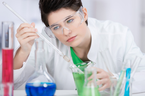 Laboratory technician doing chemical tests - Фото, изображение
