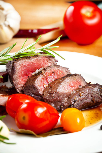 biberiye, baharat ve tabakta domates ile ızgara geyik biftek - Fotoğraf, Görsel