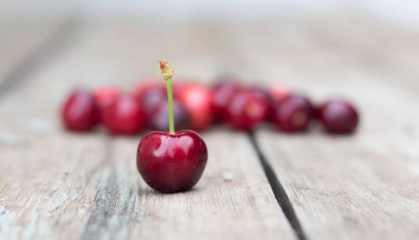 Cherries on a wooden table. - Фото, зображення