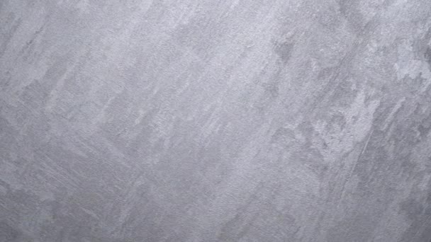 тло оштукатурених текстур з мармуровим ефектом сірого кольору. художній фон ручної роботи. Венеціанська штукатурка. Циклічне обертання тла - Кадри, відео