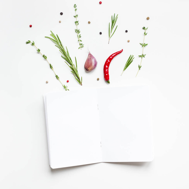 Blank notepad pages with greens herbs and spices - Фото, зображення