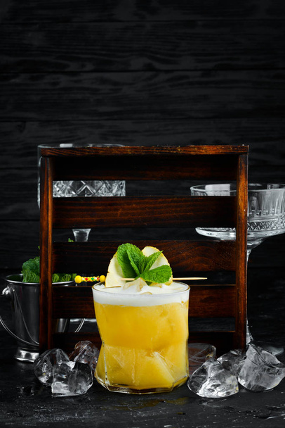 Yellow tropical drink cocktail in a glass. Passion fruit, lemon, rum. - Φωτογραφία, εικόνα