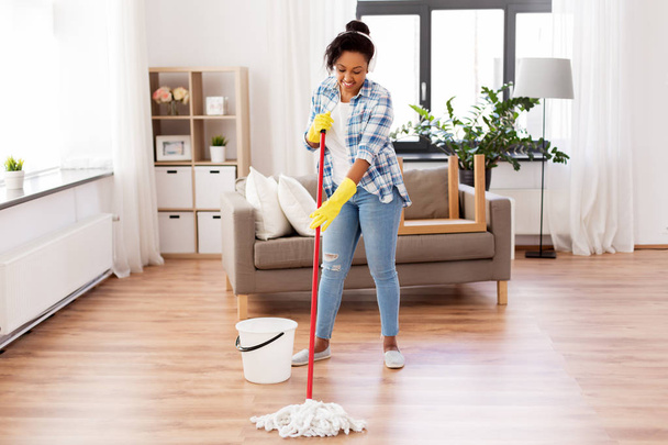 african woman or housewife cleaning floor at home - Foto, Imagem