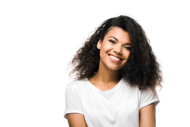 cheerful african american girl in white t-shirt looking at camera isolated on white  - Fotó, kép