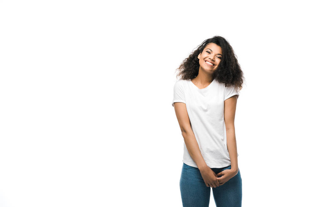 cheerful african american girl in white t-shirt standing isolated on white  - 写真・画像
