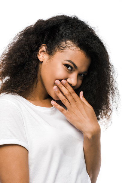 african american girl covering face with hand and looking at camera isolated on white  - Fotó, kép