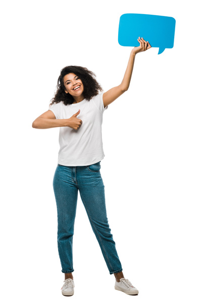 happy african american girl holding blue speech bubble and showing thumb up isolated on white  - Foto, imagen