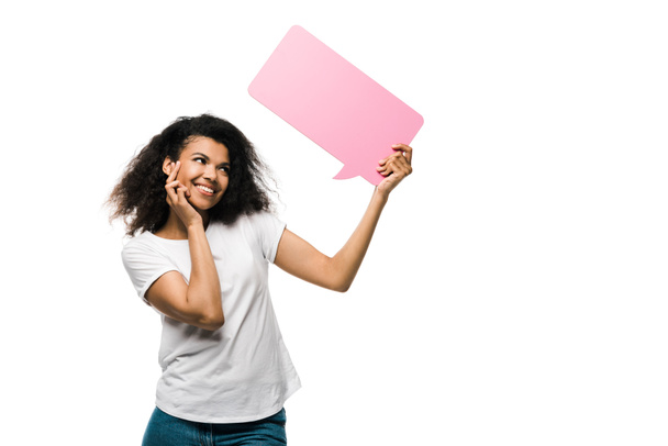 cheerful african american girl looking at pink speech bubble isolated on white  - Φωτογραφία, εικόνα