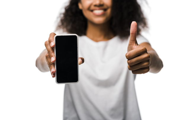 cropped view of happy african american girl holding smartphone with blank screen and showing thumb up isolated on white  - Foto, Bild
