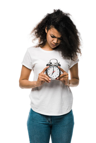 emotional curly african american girl holding vintage alarm clock isolated on white  - Photo, Image