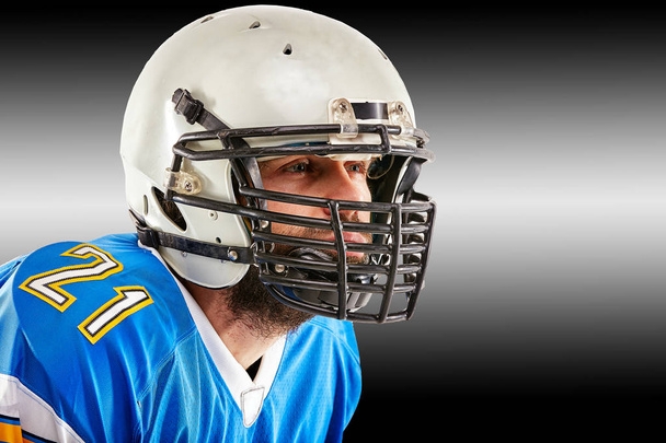 Concepto fútbol americano, retrato de futbolista americano en casco con mirada patriótica. Fondo blanco negro, espacio de copia
. - Foto, imagen