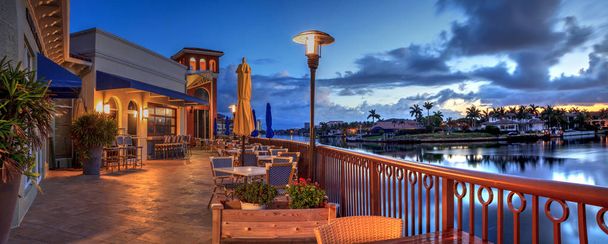 Outdoor dining at the Village at Venetian Bay at sunrise in Napl - Photo, Image