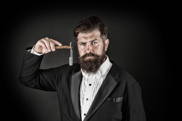 Sharp blade. Grow mustache. Growing and maintaining moustache. Man with mustache. Beard and mustache grooming. Hipster handsome bearded wear tuxedo. Barber shop concept. Shaving dangerous blade - Photo, Image