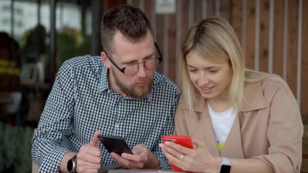 Couple using smartphone outside - Footage, Video