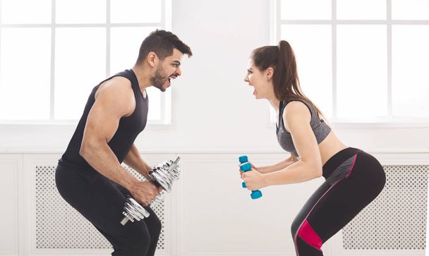 Active couple hardly working out and looking at each other - Photo, Image