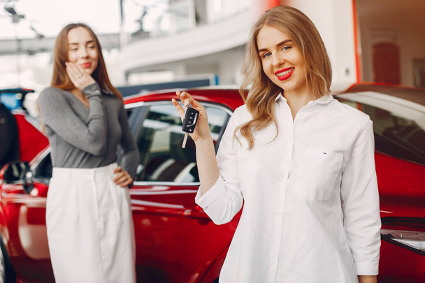 Two stylish women in a car salon - Foto, Imagem