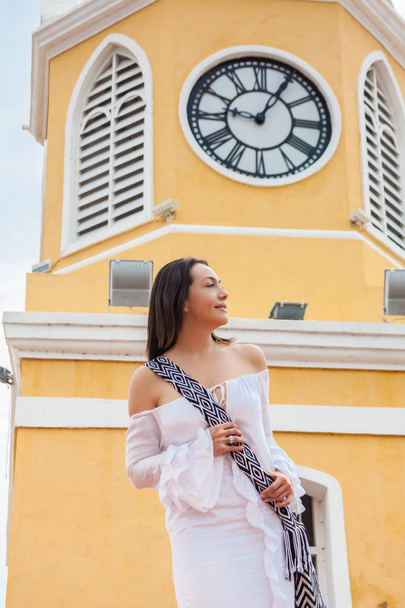 Beautiful woman walking around Cartagena de Indias next to the famous Clock Tower - Foto, imagen